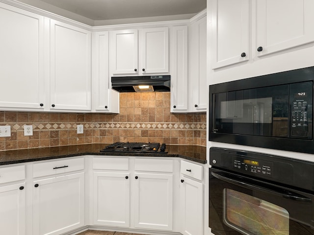 kitchen with white cabinetry, dark stone counters, and black appliances