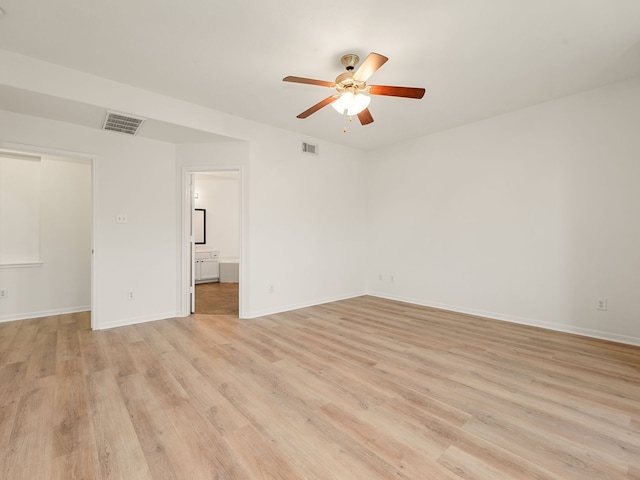 empty room with ceiling fan and light hardwood / wood-style floors