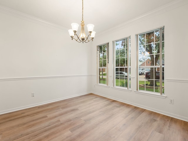 unfurnished dining area with a chandelier, crown molding, and light hardwood / wood-style floors