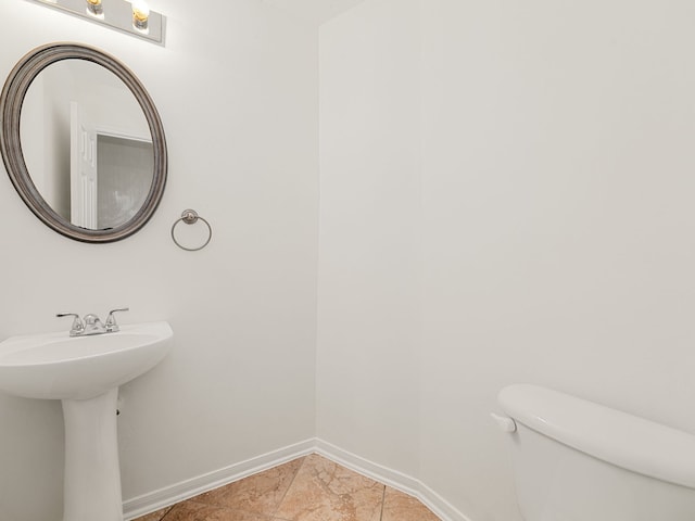 bathroom featuring tile patterned flooring, toilet, and sink