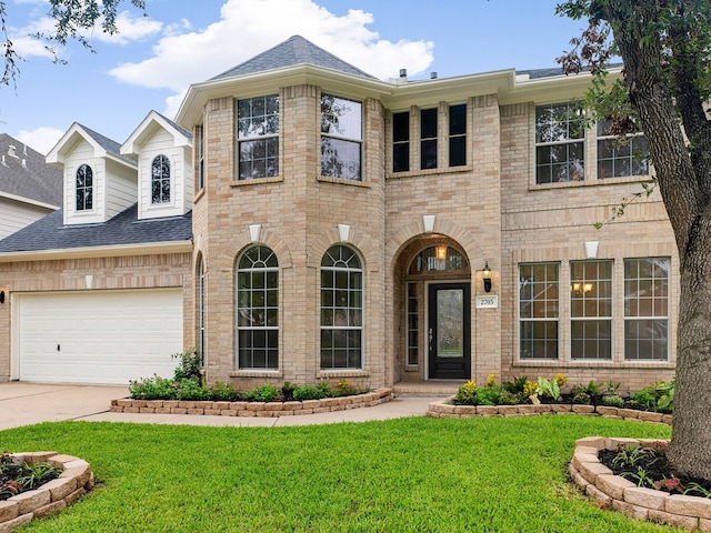 view of front of property featuring a garage and a front yard