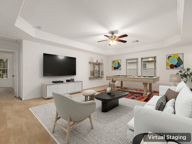 living room featuring a tray ceiling, light colored carpet, ceiling fan, crown molding, and billiards