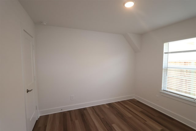 empty room with plenty of natural light and dark hardwood / wood-style floors