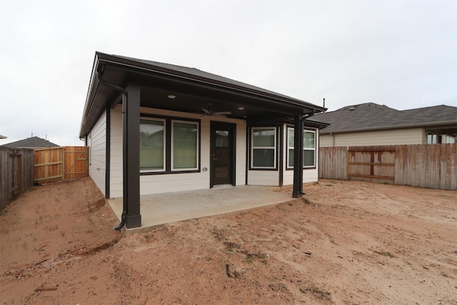 back of property featuring ceiling fan and a patio