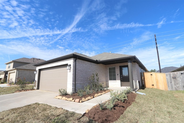 view of front of house featuring a front lawn and a garage