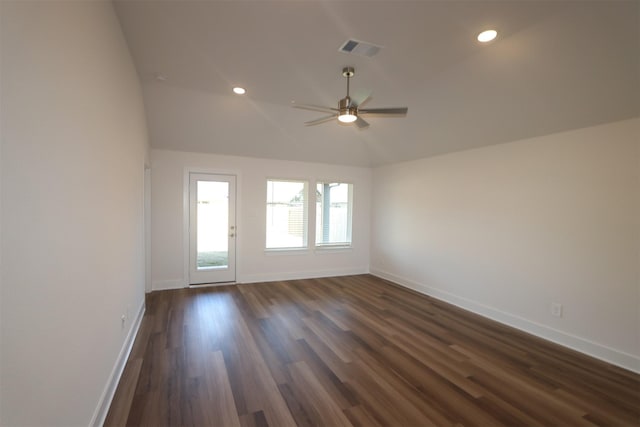 empty room with ceiling fan, vaulted ceiling, and dark hardwood / wood-style flooring