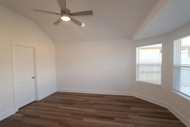 spare room with ceiling fan, dark hardwood / wood-style floors, and vaulted ceiling