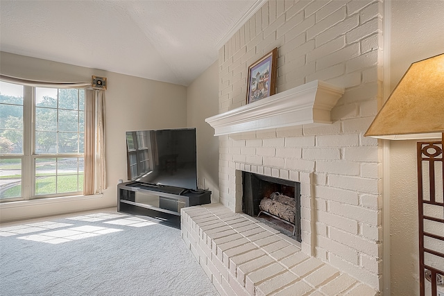 carpeted living room featuring plenty of natural light, a textured ceiling, and a brick fireplace