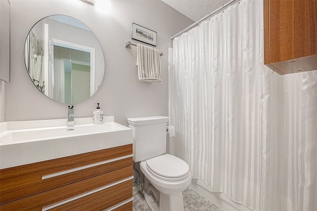 bathroom with curtained shower, vanity, a textured ceiling, and toilet