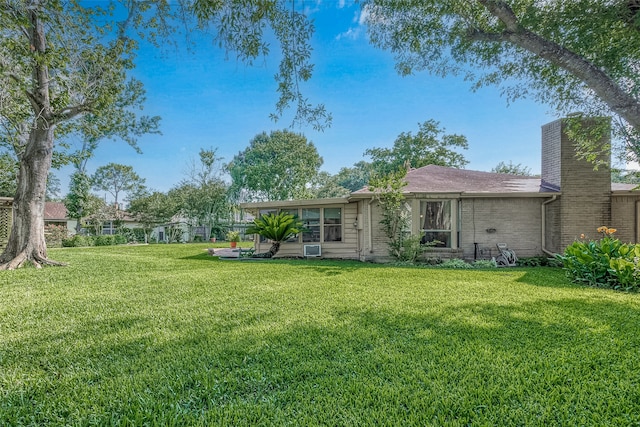 back of property featuring a lawn