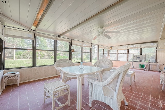 sunroom / solarium with lofted ceiling with beams, wood ceiling, a wealth of natural light, and ceiling fan