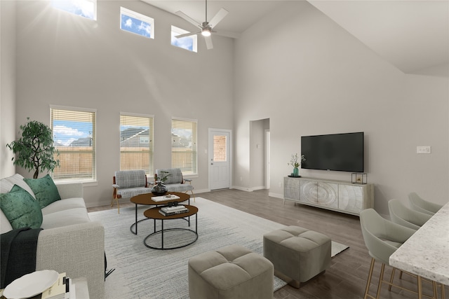 living room featuring high vaulted ceiling, hardwood / wood-style floors, and ceiling fan