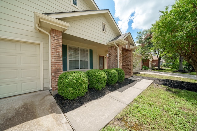 view of exterior entry with a garage