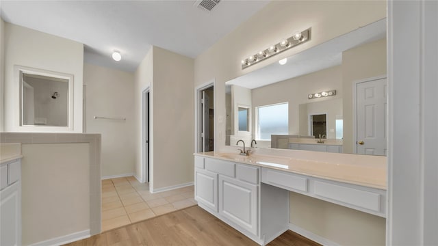 bathroom with hardwood / wood-style flooring and vanity