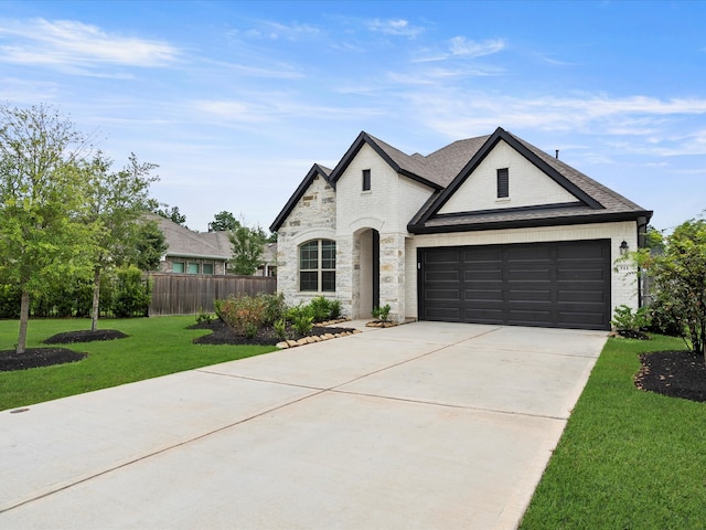 french provincial home with a garage and a front lawn