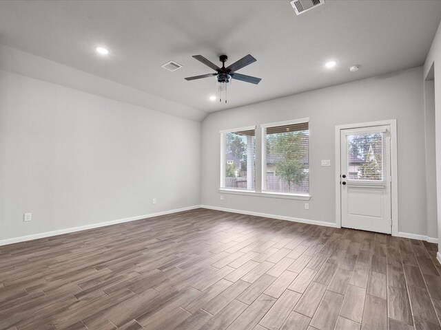 empty room featuring wood-type flooring, ceiling fan, and plenty of natural light