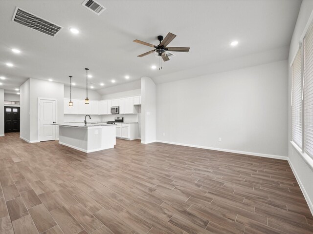 unfurnished living room featuring ceiling fan, light hardwood / wood-style flooring, and sink