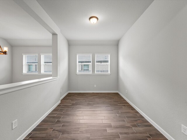 spare room with dark hardwood / wood-style floors and a wealth of natural light