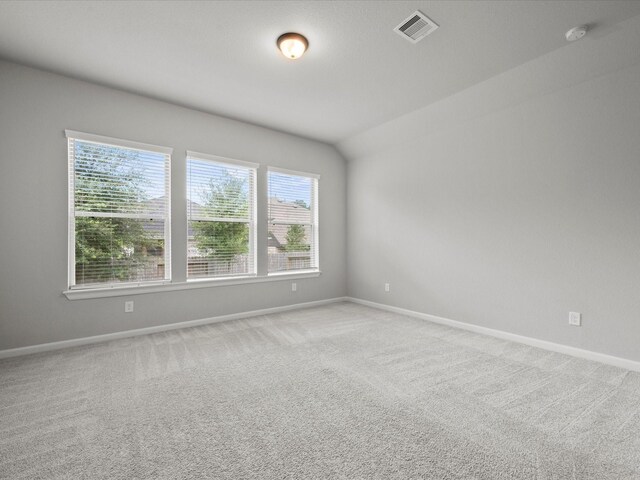 unfurnished room featuring light colored carpet