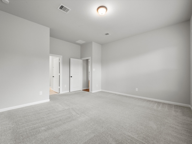 spare room featuring light colored carpet