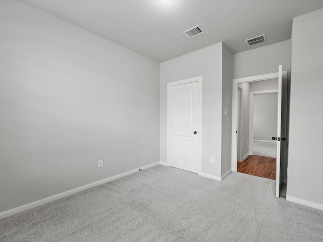 unfurnished bedroom with light colored carpet