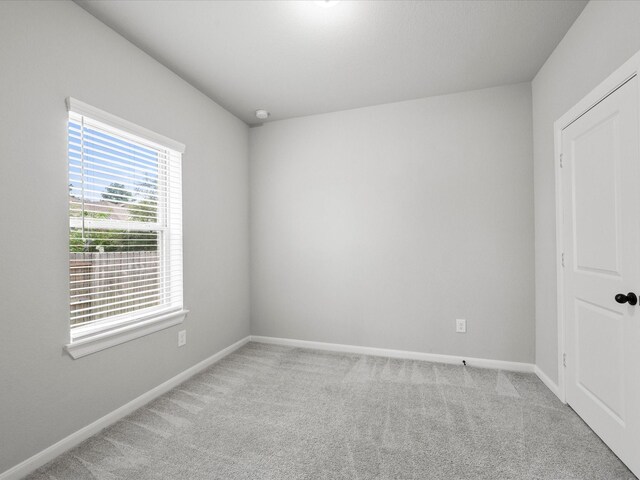 spare room with light colored carpet