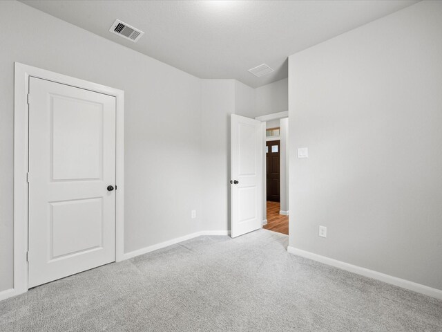 unfurnished bedroom with light colored carpet