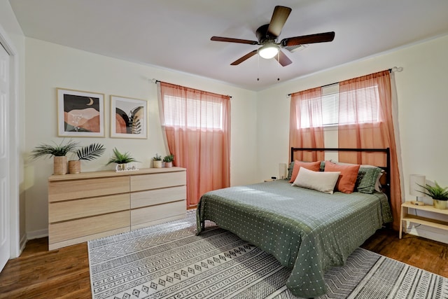 bedroom featuring multiple windows, ceiling fan, and dark hardwood / wood-style floors