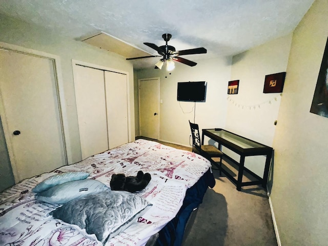 carpeted bedroom featuring ceiling fan and multiple closets