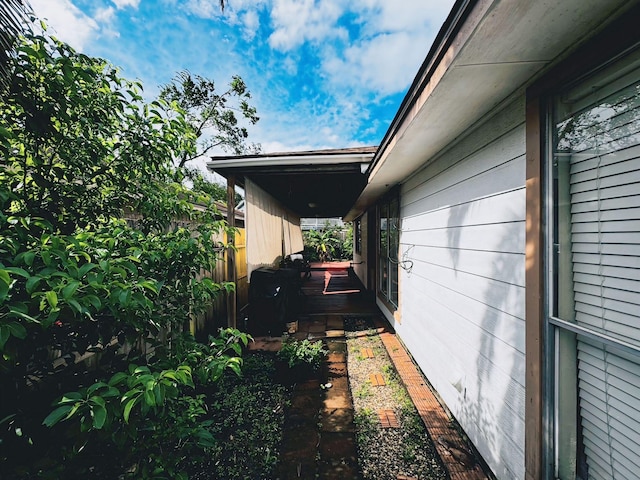 view of side of home featuring fence