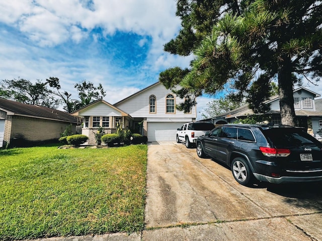 view of front of property featuring a front yard and a garage