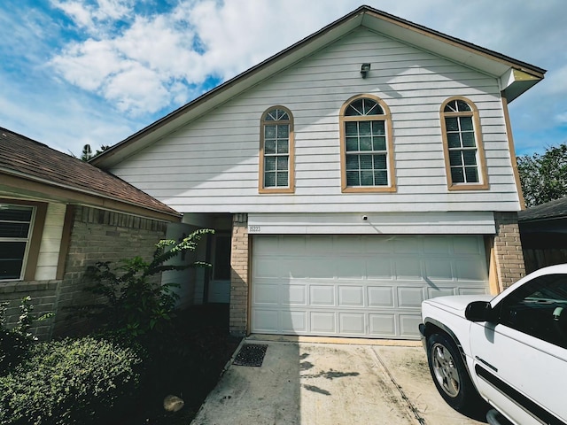 view of property exterior featuring a garage, brick siding, and concrete driveway