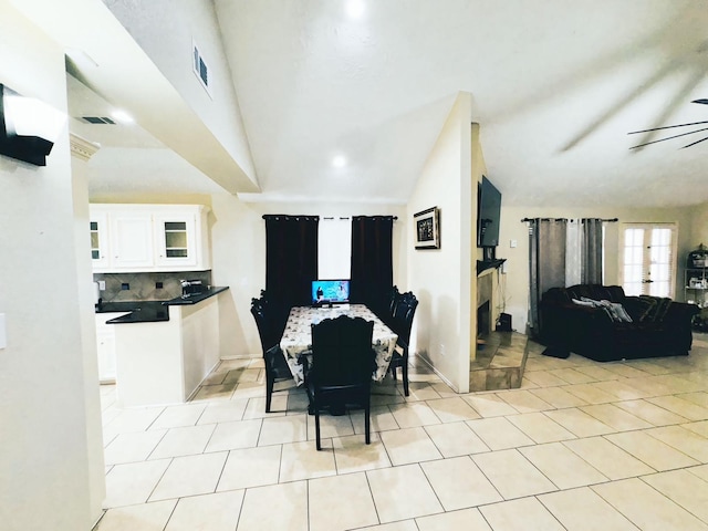 dining room with visible vents, lofted ceiling, and a ceiling fan