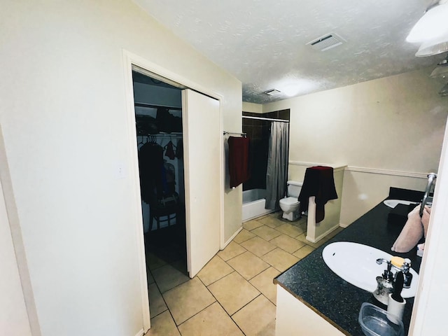 bathroom with tile patterned floors, a shower with curtain, a textured ceiling, and vanity