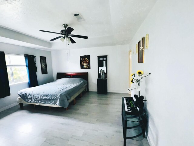 bedroom featuring visible vents, a ceiling fan, and baseboards