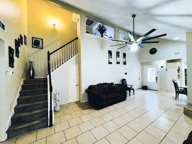 living room with high vaulted ceiling, light tile patterned floors, and ceiling fan