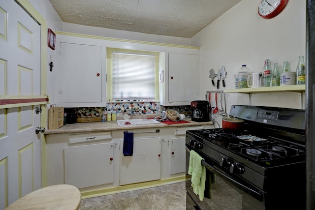 kitchen with white cabinets, black gas range oven, decorative backsplash, and a textured ceiling