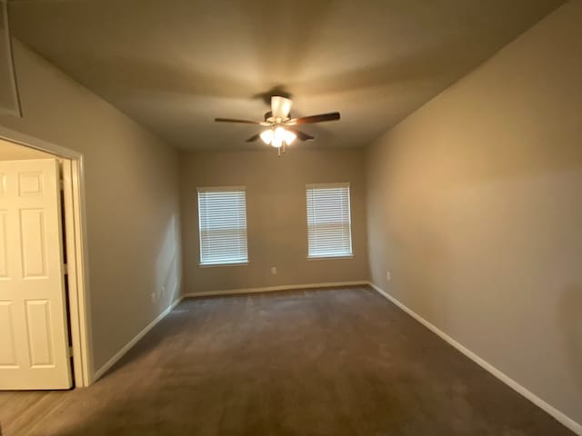 carpeted spare room with ceiling fan