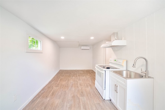 clothes washing area with light wood-type flooring and sink