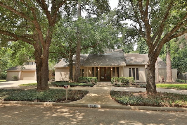 view of front facade featuring a garage and french doors