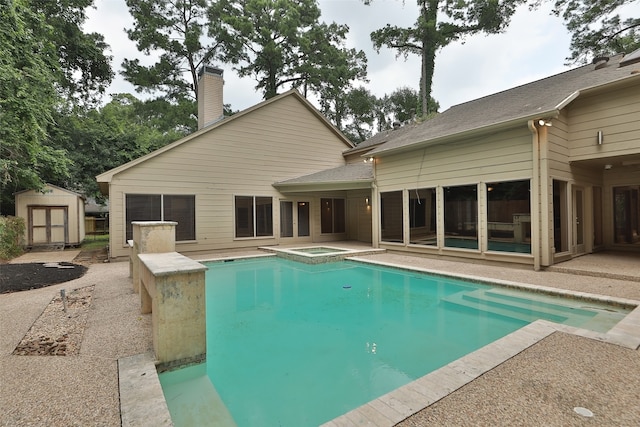 view of pool featuring a shed and a patio area