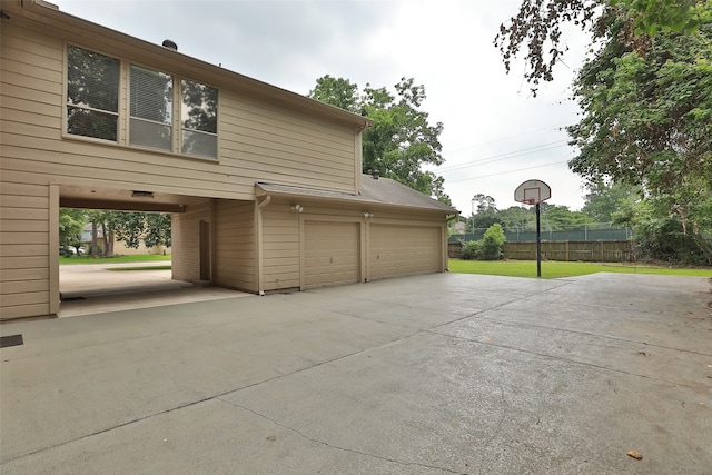 garage with a lawn and wooden walls