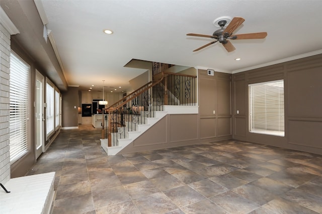 unfurnished room featuring ceiling fan and ornamental molding