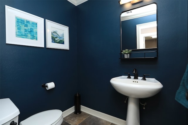 bathroom with toilet and ornamental molding