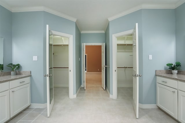 bathroom featuring ornamental molding, vanity, and tile patterned flooring