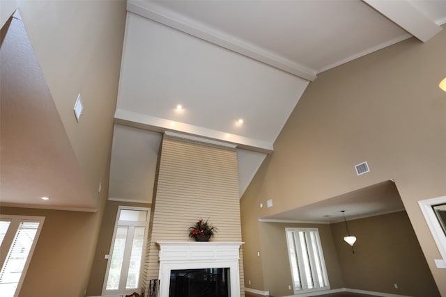 interior details featuring ornamental molding and a fireplace