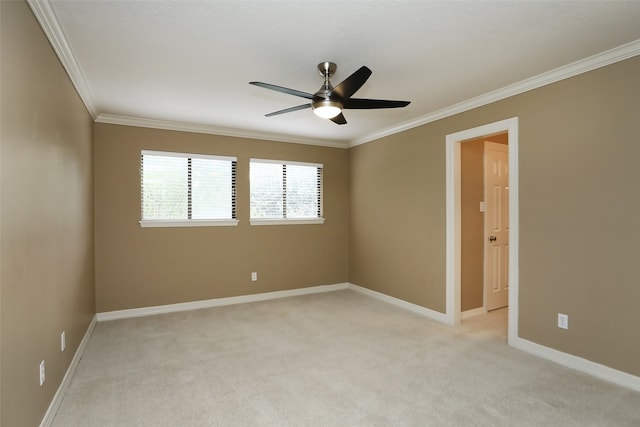 empty room featuring crown molding, light colored carpet, and ceiling fan