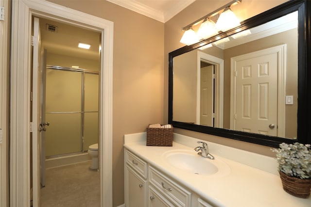 bathroom with crown molding, vanity, a shower with shower door, and toilet