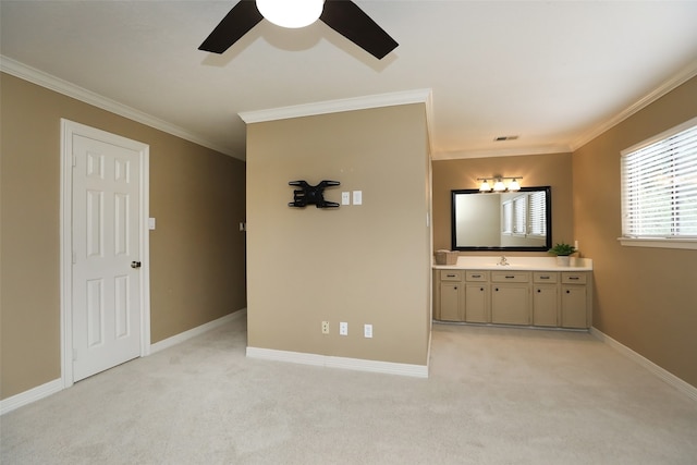 unfurnished bedroom with crown molding, connected bathroom, and light carpet