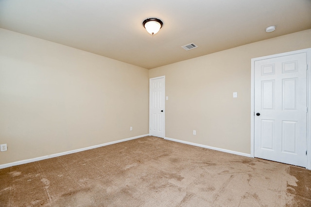 unfurnished room featuring light carpet